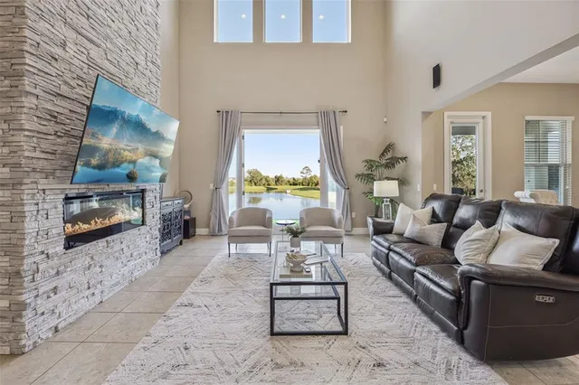 a living room with furniture wooden floor and a fireplace
