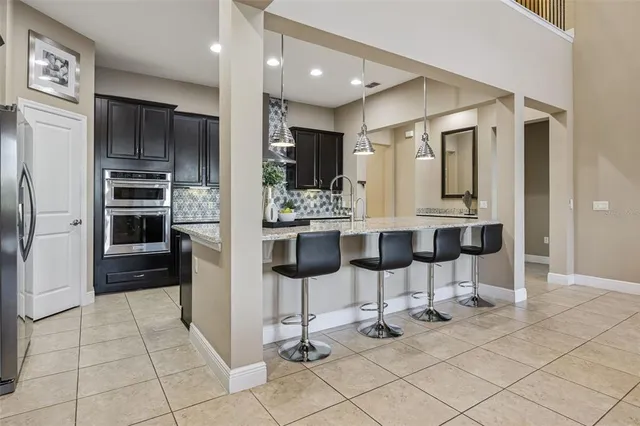 a kitchen with stainless steel appliances granite countertop a sink and cabinets