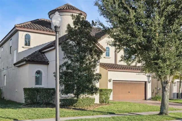 a front view of a house with a garden and garage