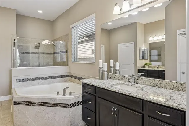 an aerial view of a house with pool and garden