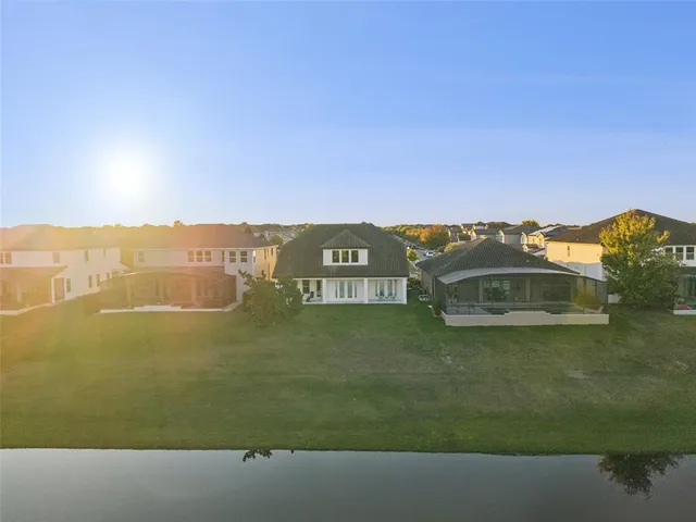 a view of a backyard with table and chairs under an umbrella with a small yard