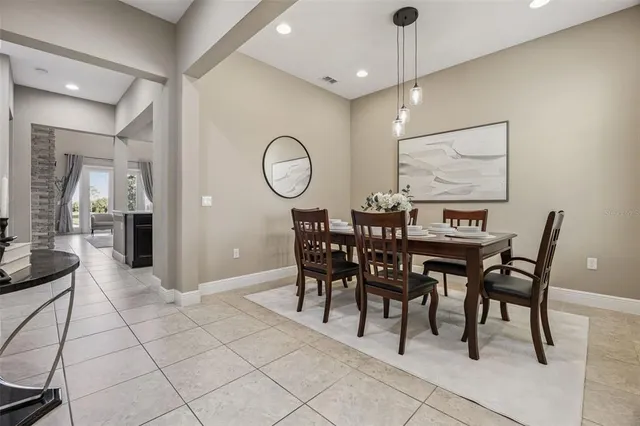 a living room with fireplace furniture and a rug
