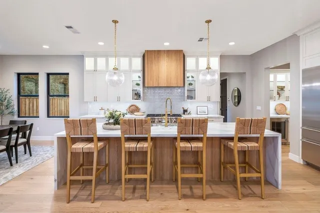 a bathroom with a sink a toilet a mirror and a tub