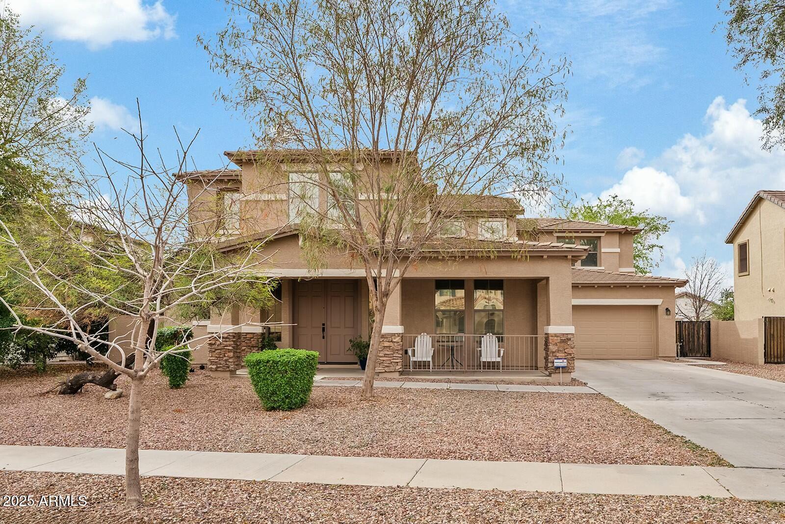 3353 East Blue Ridge Way Gilbert, AZ 85298 - Photo 1 of 50 a front view of a building with garden