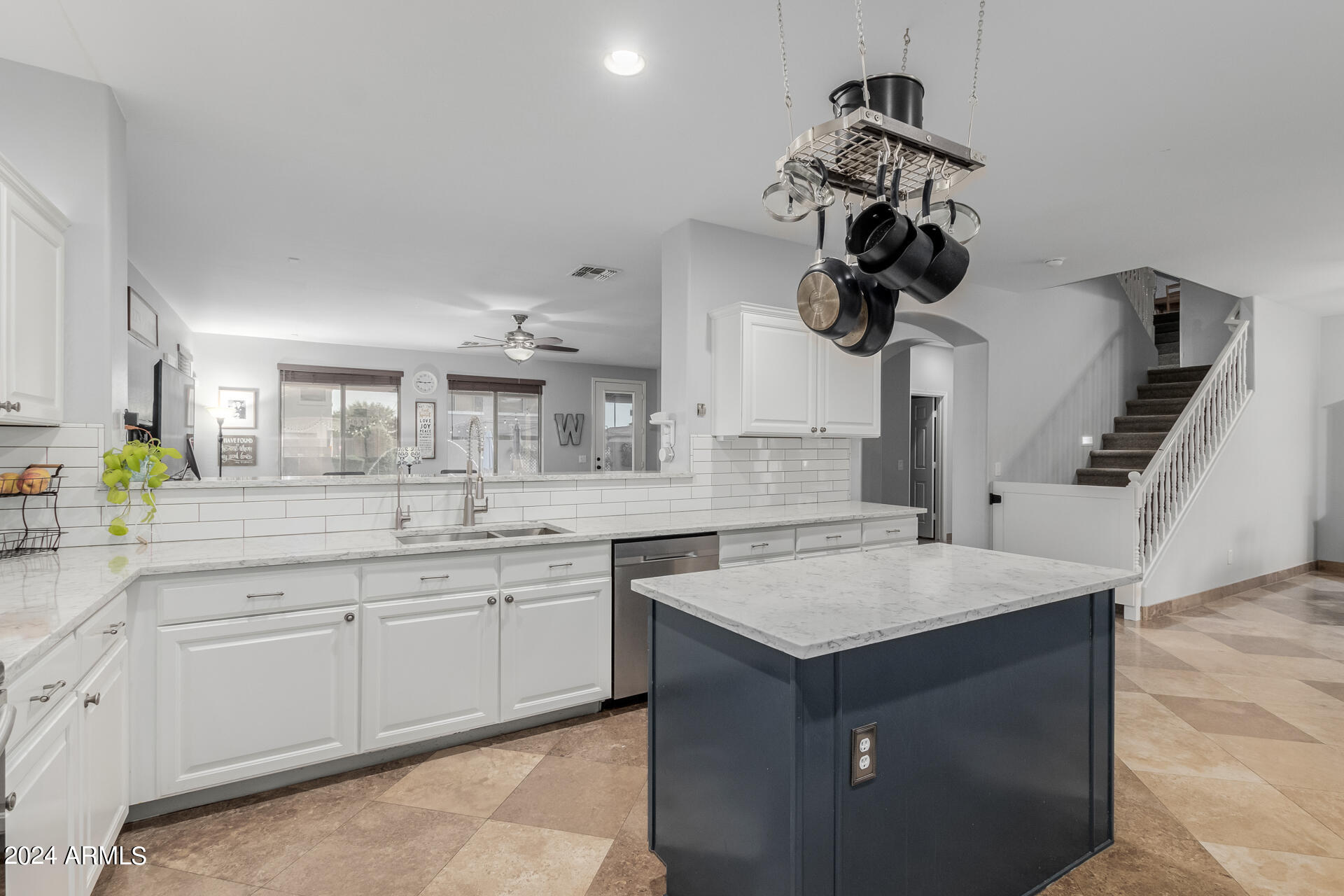 3353 East Blue Ridge Way Gilbert, AZ 85298 - Photo 14 of 50 a kitchen with a sink dishwasher and a stove with wooden floor