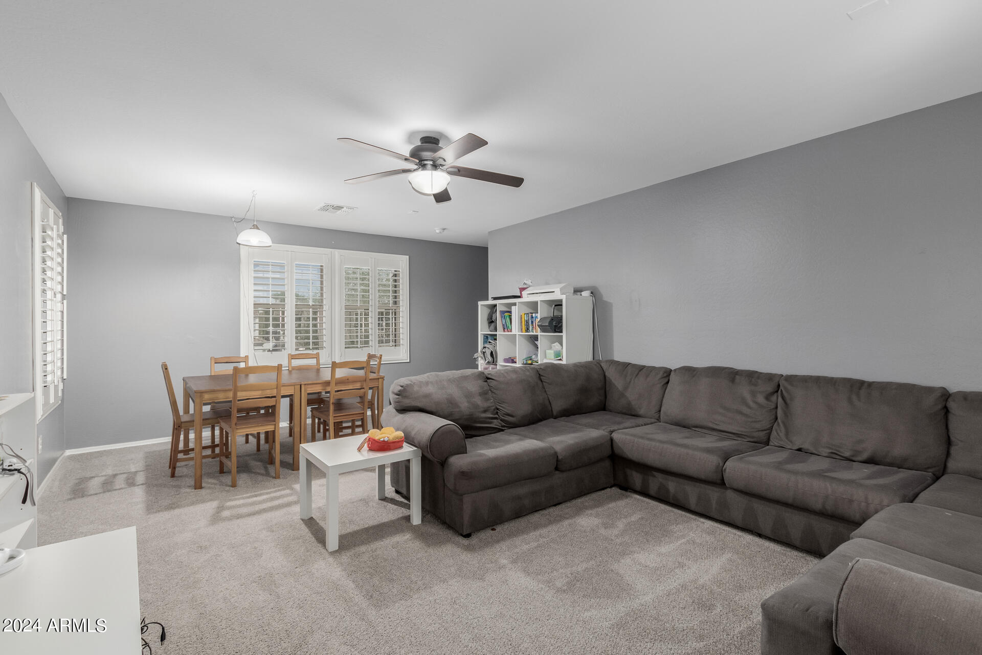 3353 East Blue Ridge Way Gilbert, AZ 85298 - Photo 29 of 50 a living room with furniture a dining table and a couch