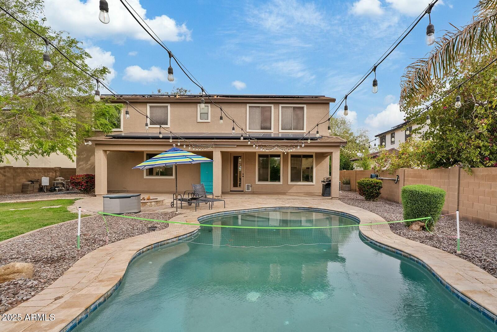 3353 East Blue Ridge Way Gilbert, AZ 85298 - Photo 38 of 50 a front view of a house with a yard table and chairs
