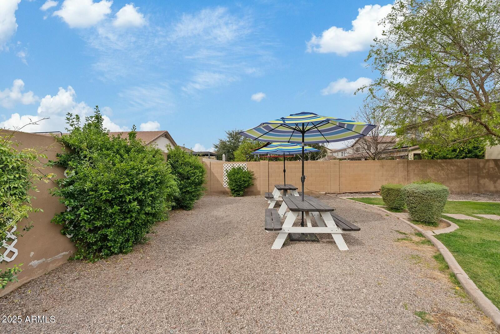 3353 East Blue Ridge Way Gilbert, AZ 85298 - Photo 50 of 50 a lawn chair sitting in the backyard of a house
