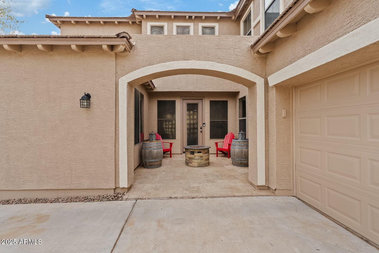 3353 East Blue Ridge Way Gilbert, AZ 85298 - Photo 5 of 50 front view of a brick house with a sitting area