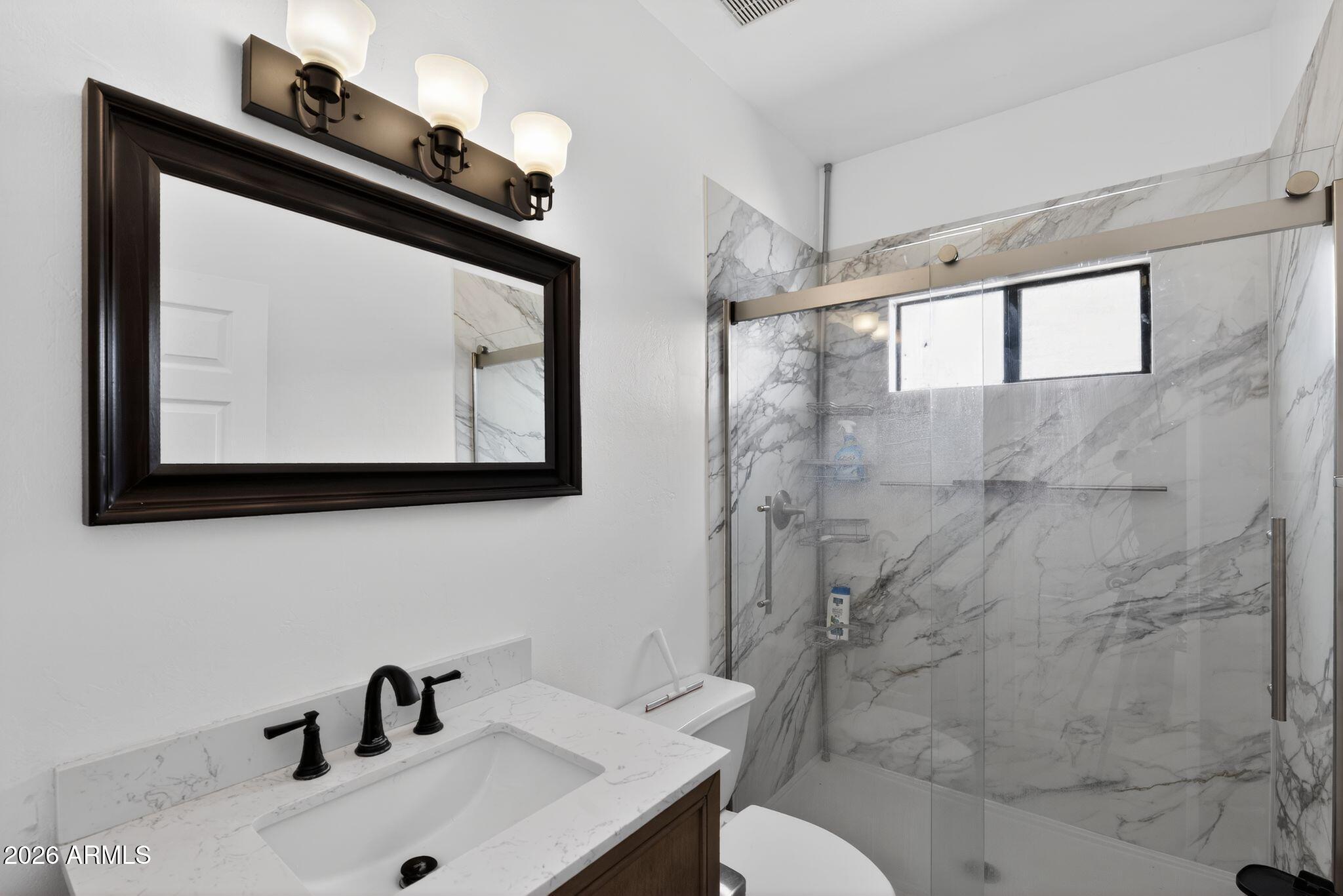 277 Círculo Silva Rio Rico, AZ 85648 - Photo 20 of 34 a bathroom with a sink and a mirror