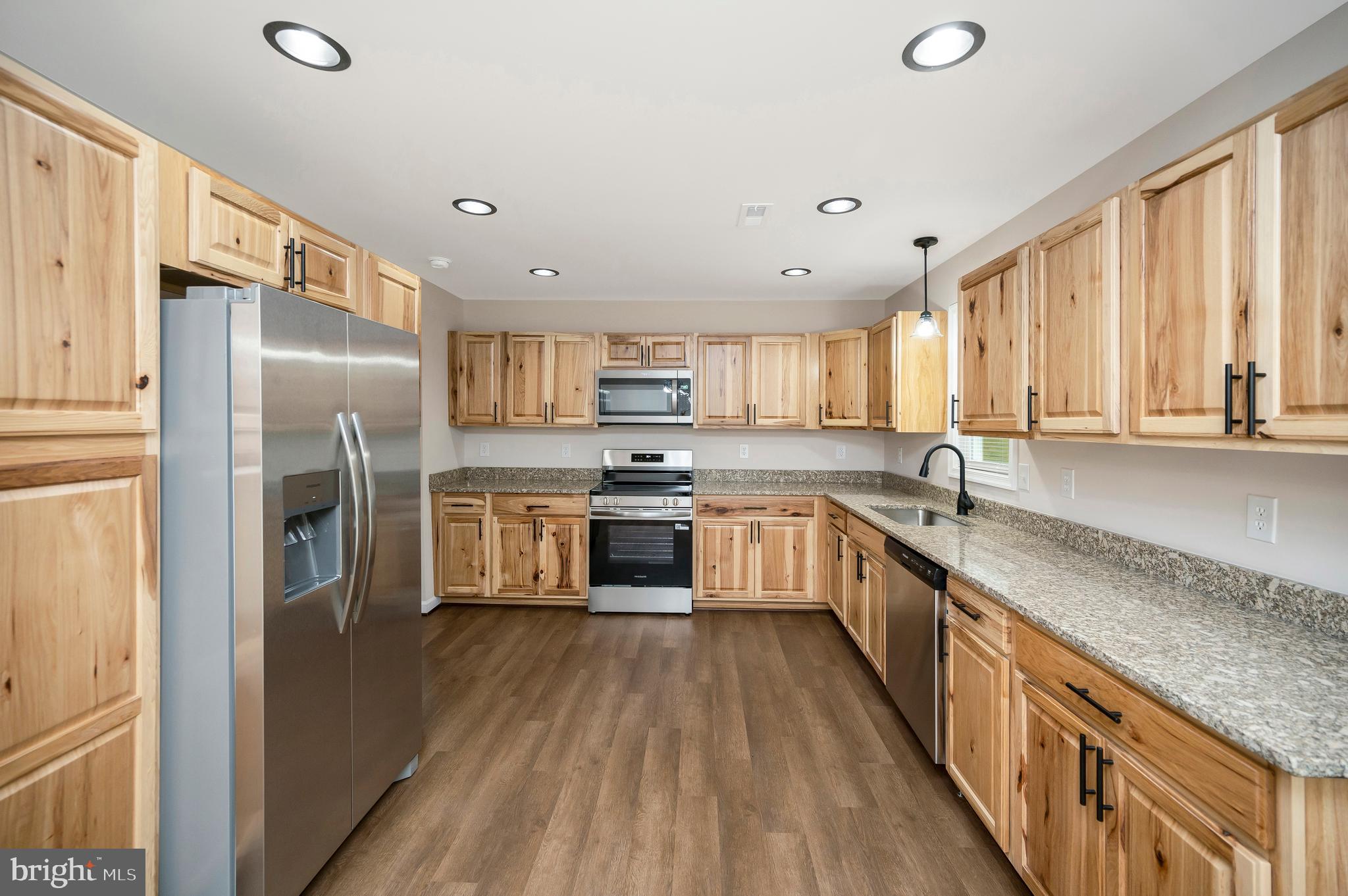 14169 Silver Hill Road Sumerduck, VA 22742 - Photo 13 of 40 a large kitchen with stainless steel appliances granite countertop a large counter top a sink a refrigerator and cabinets