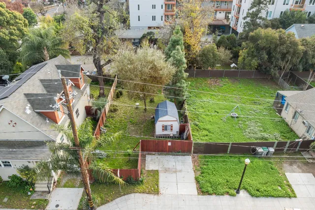 an aerial view of a houses with a yard