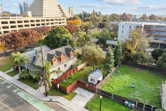 an aerial view of residential houses with outdoor space and river