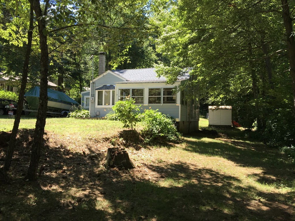 8 Craig Road Holland, MA 01521 - Photo 21 of 24 a front view of a house with a yard and trees