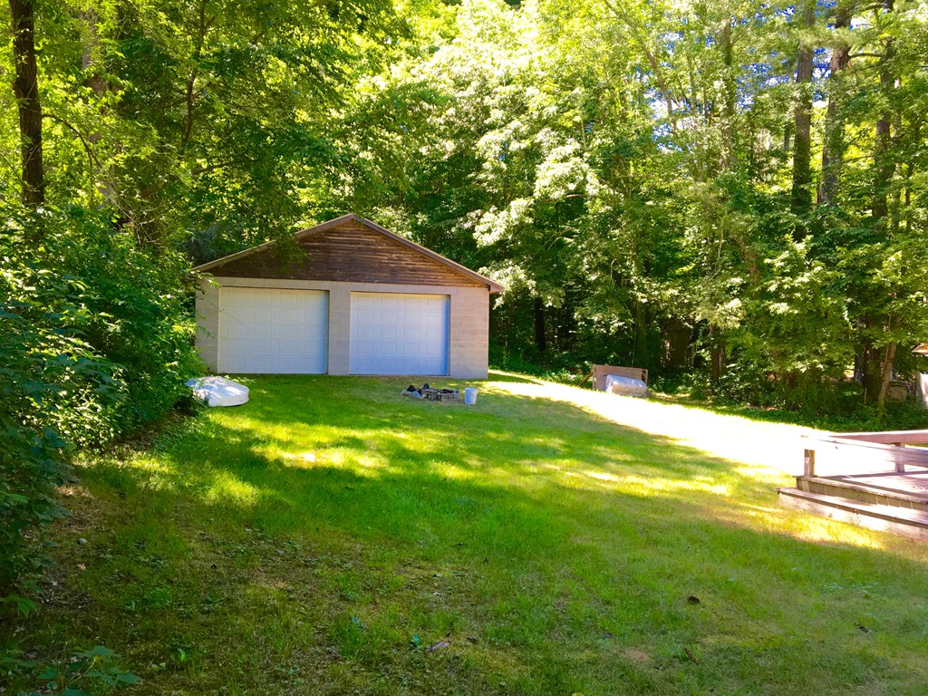 8 Craig Road Holland, MA 01521 - Photo 3 of 24 a backyard of a house with lots of green space and garden view