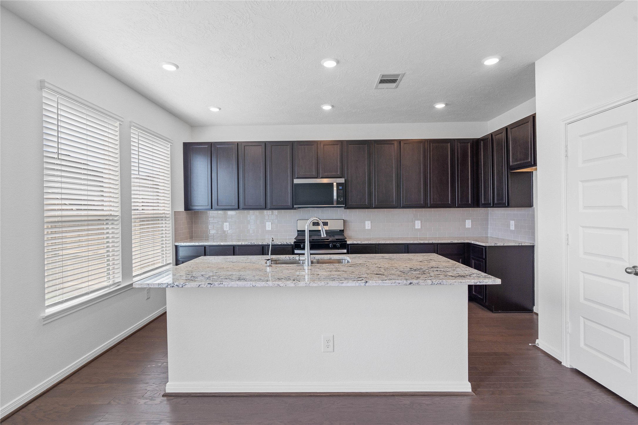 25503 Alpine Switchback Drive Spring, TX 77373 - Photo 10 of 32 This gorgeous kitchen features a large kitchen island and added breakfast bar to kitchen countertop!