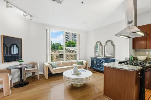 a living room with furniture a fireplace and a table