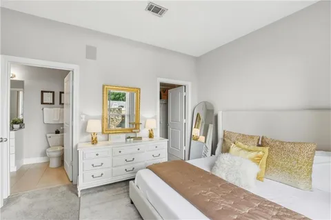 a spacious bedroom with a bed and a couch