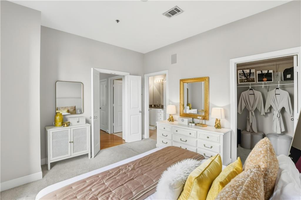 2626 Peachtree Road Northwest, Unit 606 Atlanta, GA 30305 - Photo 13 of 27 a spacious bedroom with a bed and a view of living room