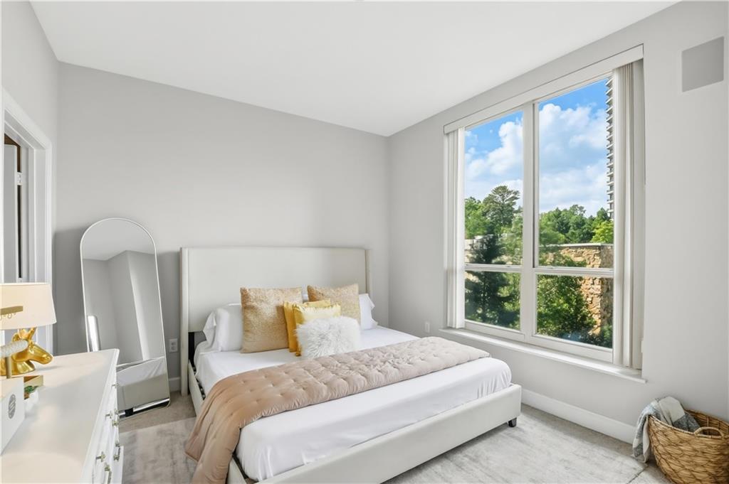 2626 Peachtree Road Northwest, Unit 606 Atlanta, GA 30305 - Photo 14 of 27 a bedroom with a bed and window