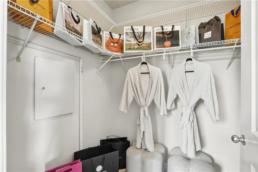 2626 Peachtree Road Northwest, Unit 606 Atlanta, GA 30305 - Photo 16 of 27 a view of walk in closet with clothes and shoes