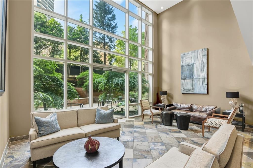 2626 Peachtree Road Northwest, Unit 606 Atlanta, GA 30305 - Photo 22 of 27 a living room with furniture and a window