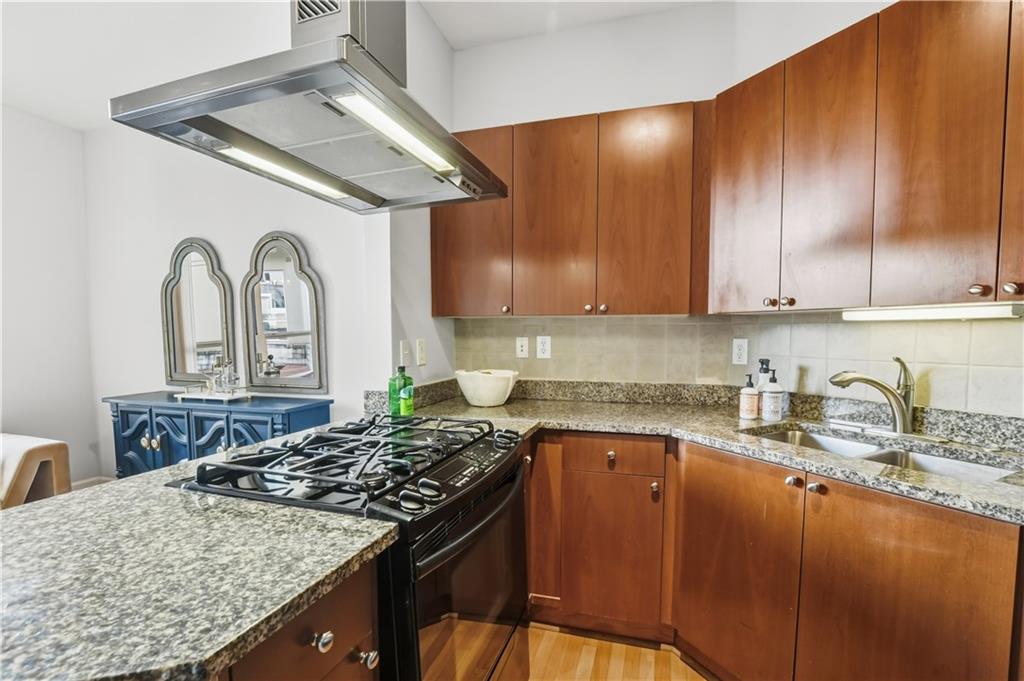 2626 Peachtree Road Northwest, Unit 606 Atlanta, GA 30305 - Photo 8 of 27 a kitchen with a stove and a sink