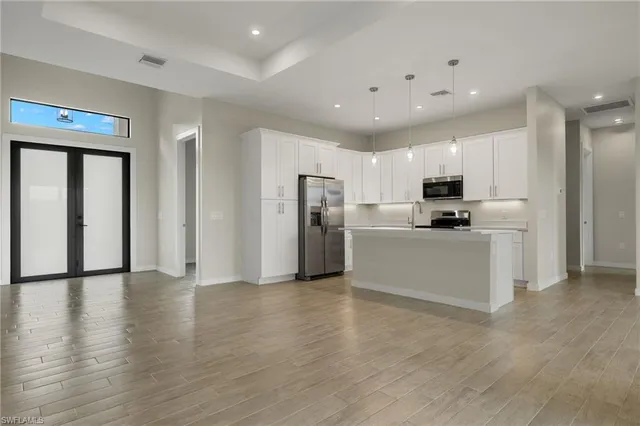 a view of kitchen with stainless steel appliances refrigerator and microwave