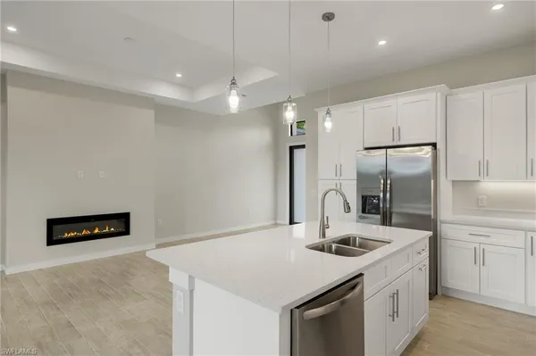 a kitchen with a sink a counter space and stainless steel appliances