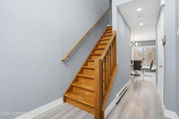 a kitchen with stainless steel appliances granite countertop a refrigerator a sink dishwasher a stove with wooden cabinets and floor