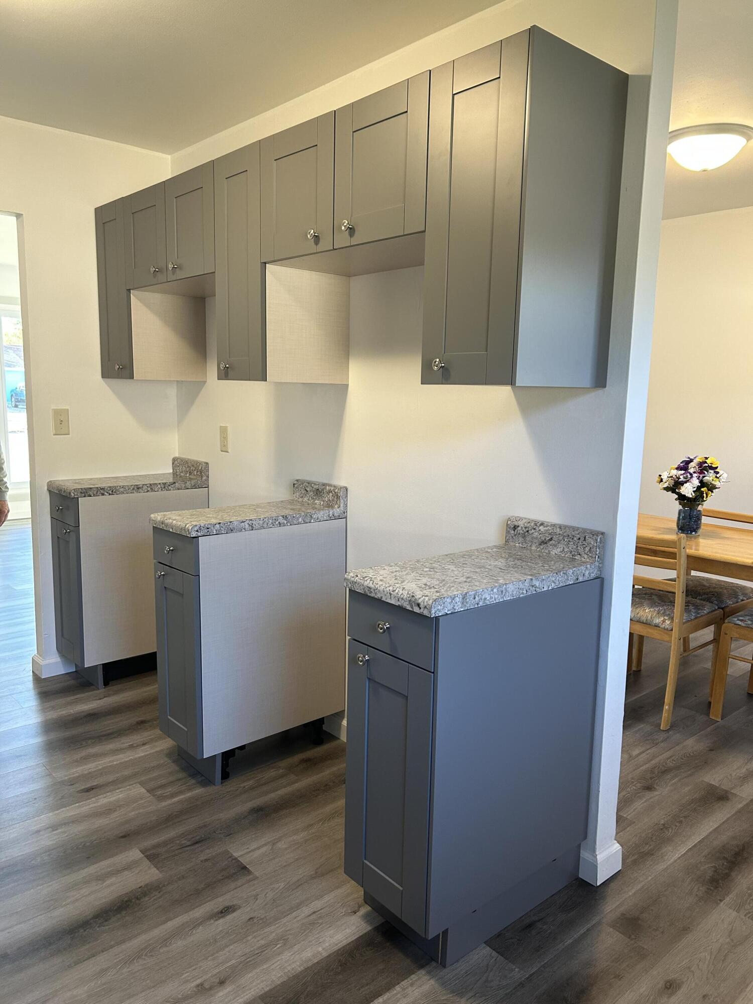 511 South Wayne Street Gary, IN 46403 - Photo 6 of 15 a kitchen with granite countertop cabinets and sink