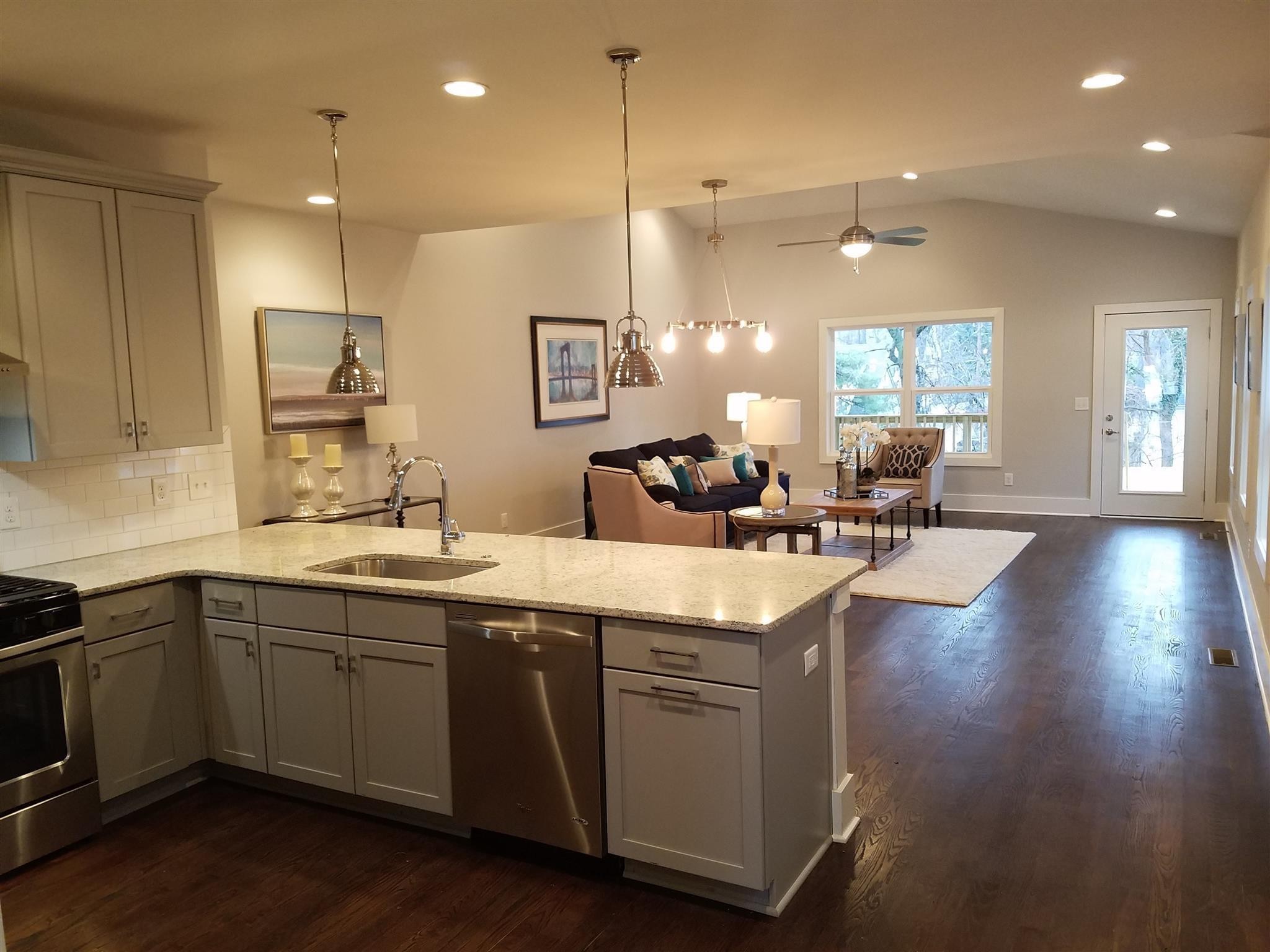 a large kitchen with lots of counter space sink and a refrigerator