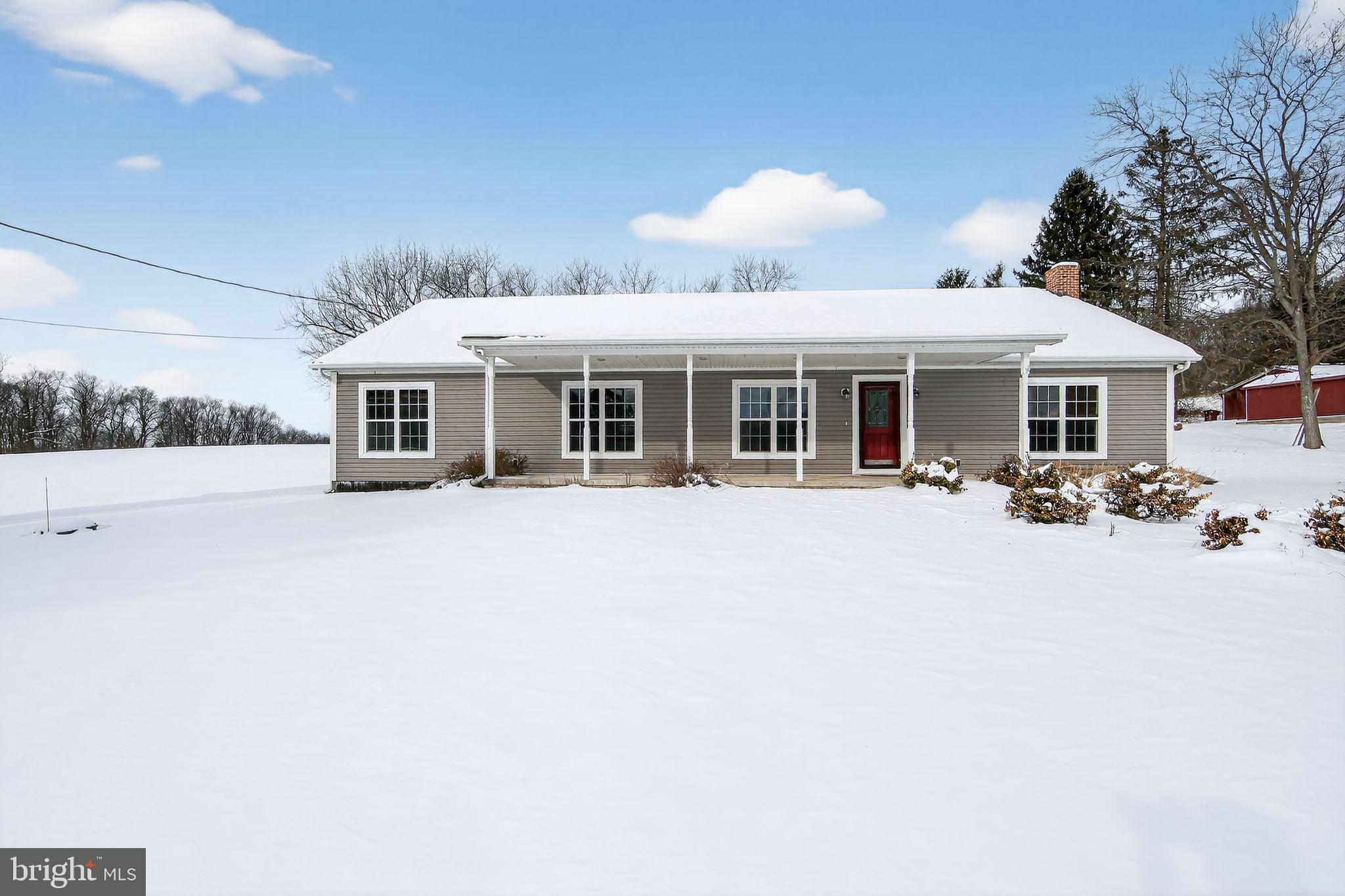 a view of a white house with a swimming pool and a chairs