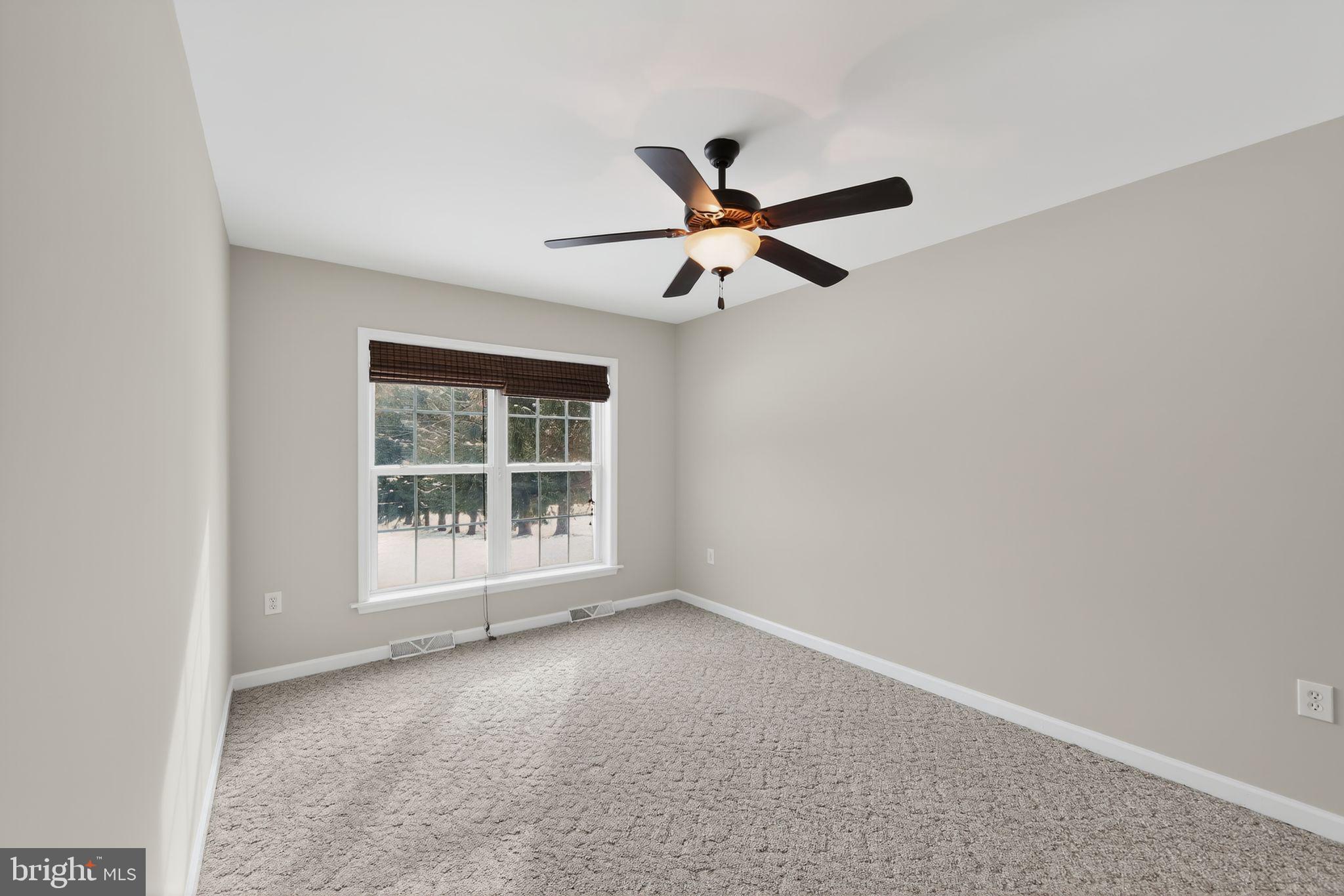 3211 Coventryville Road Pottstown, PA 19465 - Photo 18 of 37 an empty room with a window and a fan