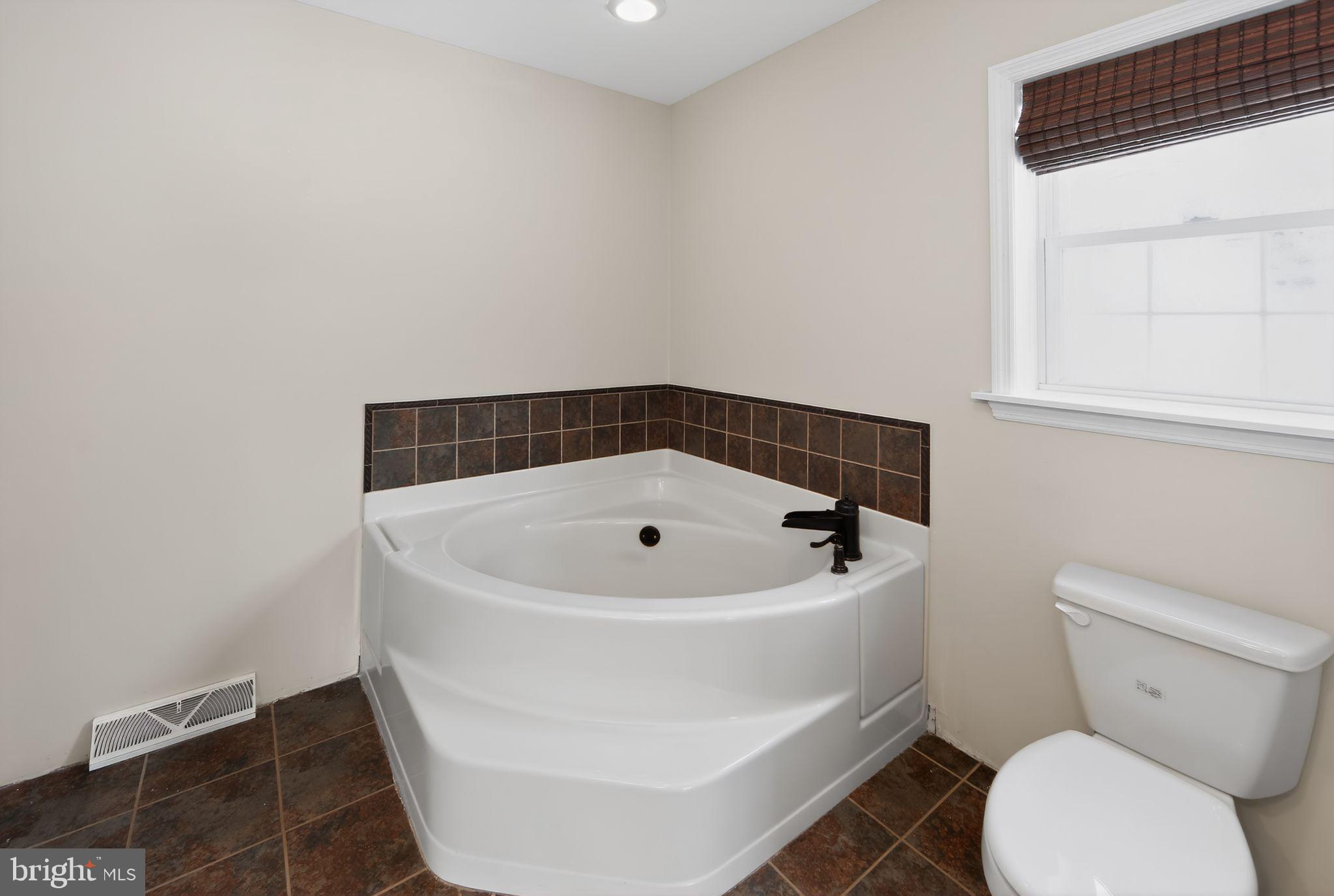 3211 Coventryville Road Pottstown, PA 19465 - Photo 23 of 37 a white bath tub sitting in a bathroom