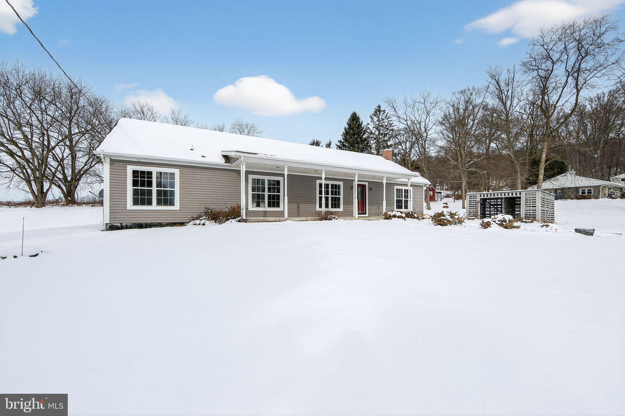 3211 Coventryville Road Pottstown, PA 19465 - Photo 30 of 37 a view of a white house with large windows and a outdoor space