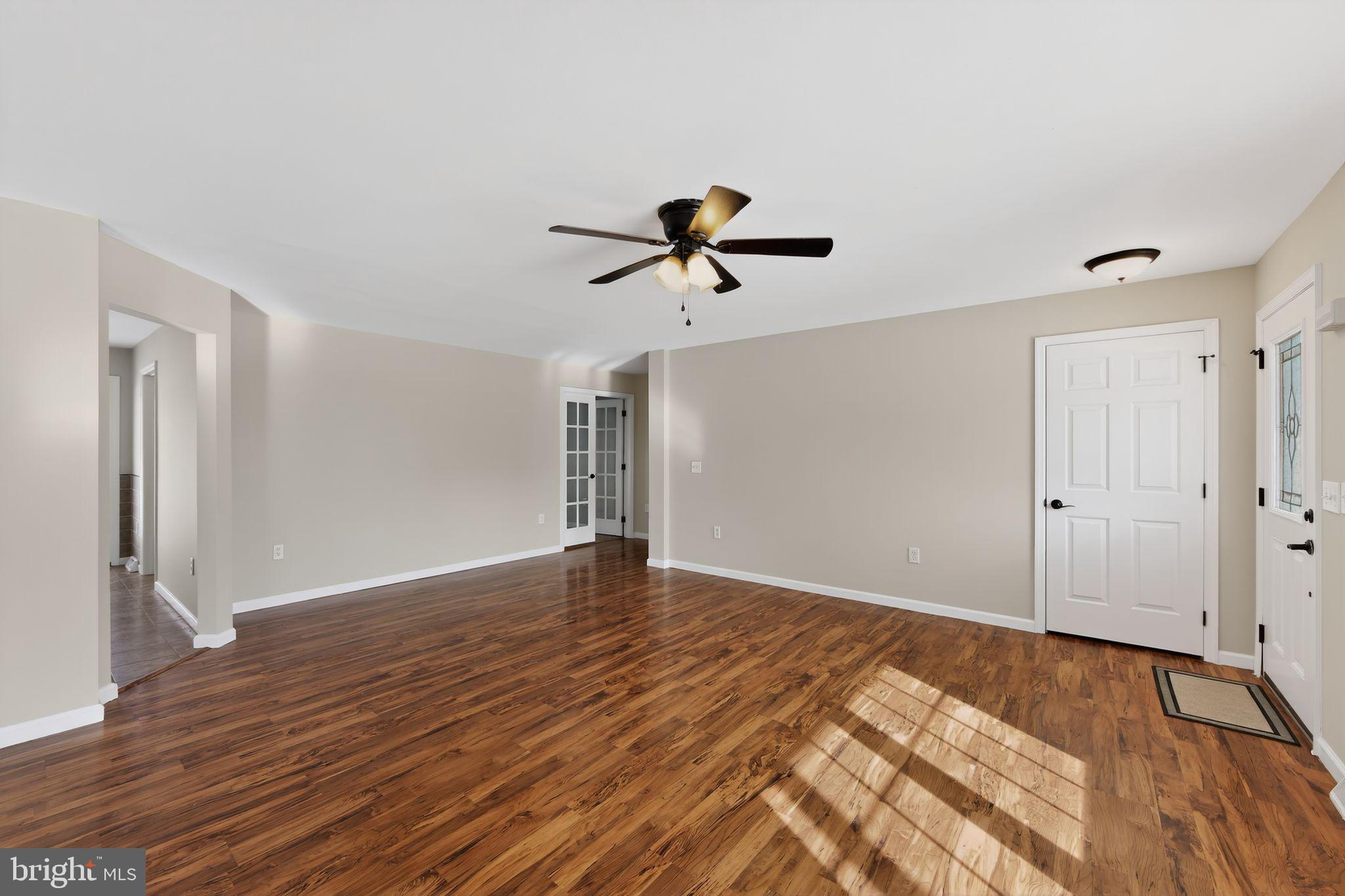 3211 Coventryville Road Pottstown, PA 19465 - Photo 3 of 37 a view of a room with wooden floor and a ceiling fan