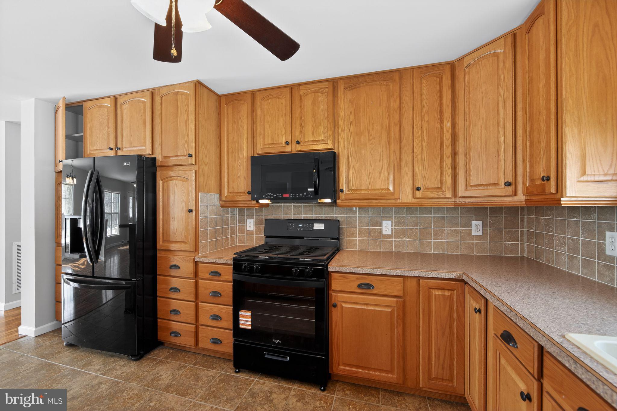 3211 Coventryville Road Pottstown, PA 19465 - Photo 7 of 37 a kitchen with stainless steel appliances a refrigerator stove and cabinets