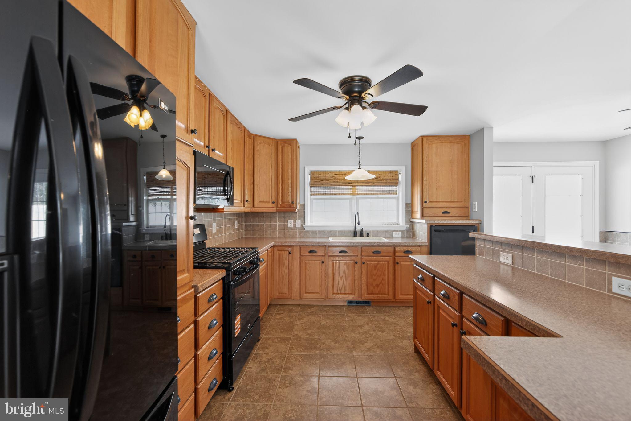 3211 Coventryville Road Pottstown, PA 19465 - Photo 8 of 37 a kitchen with stainless steel appliances granite countertop a sink a stove and a refrigerator