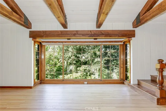 a view of a door and wooden floor