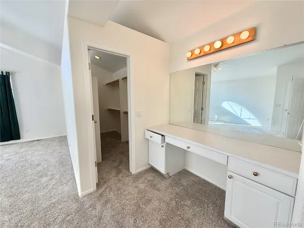 a view of cabinets with a sink and mirror
