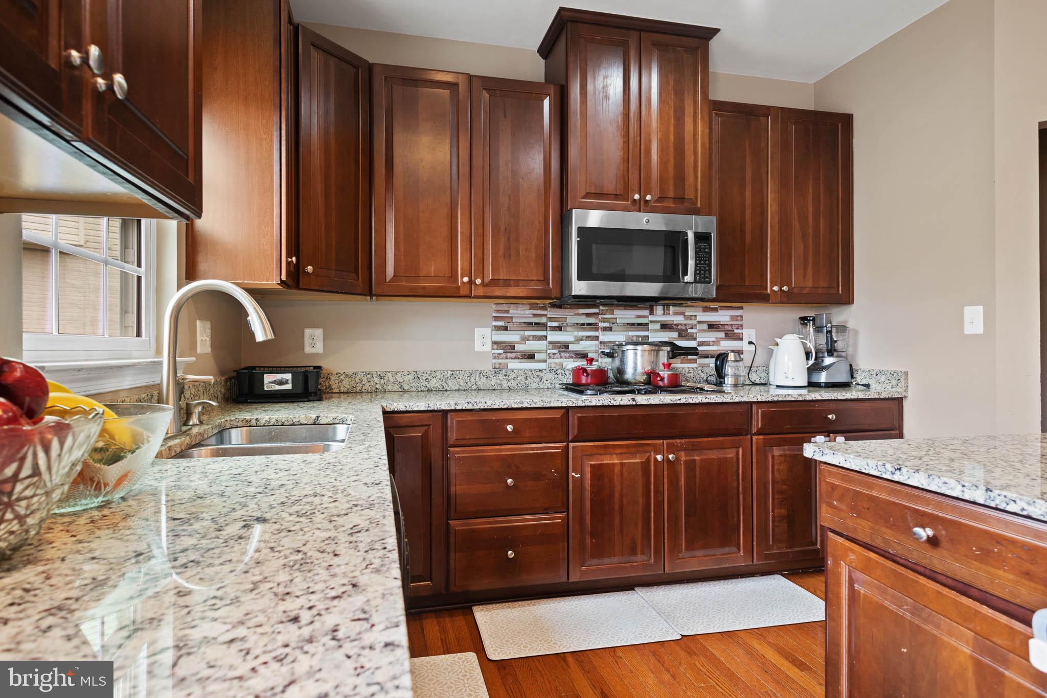3214 Fledgling Circle Woodbridge, VA 22193 - Photo 14 of 29 Modern kitchen with rich wood accents.