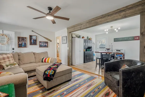 a living room with furniture and a chandelier
