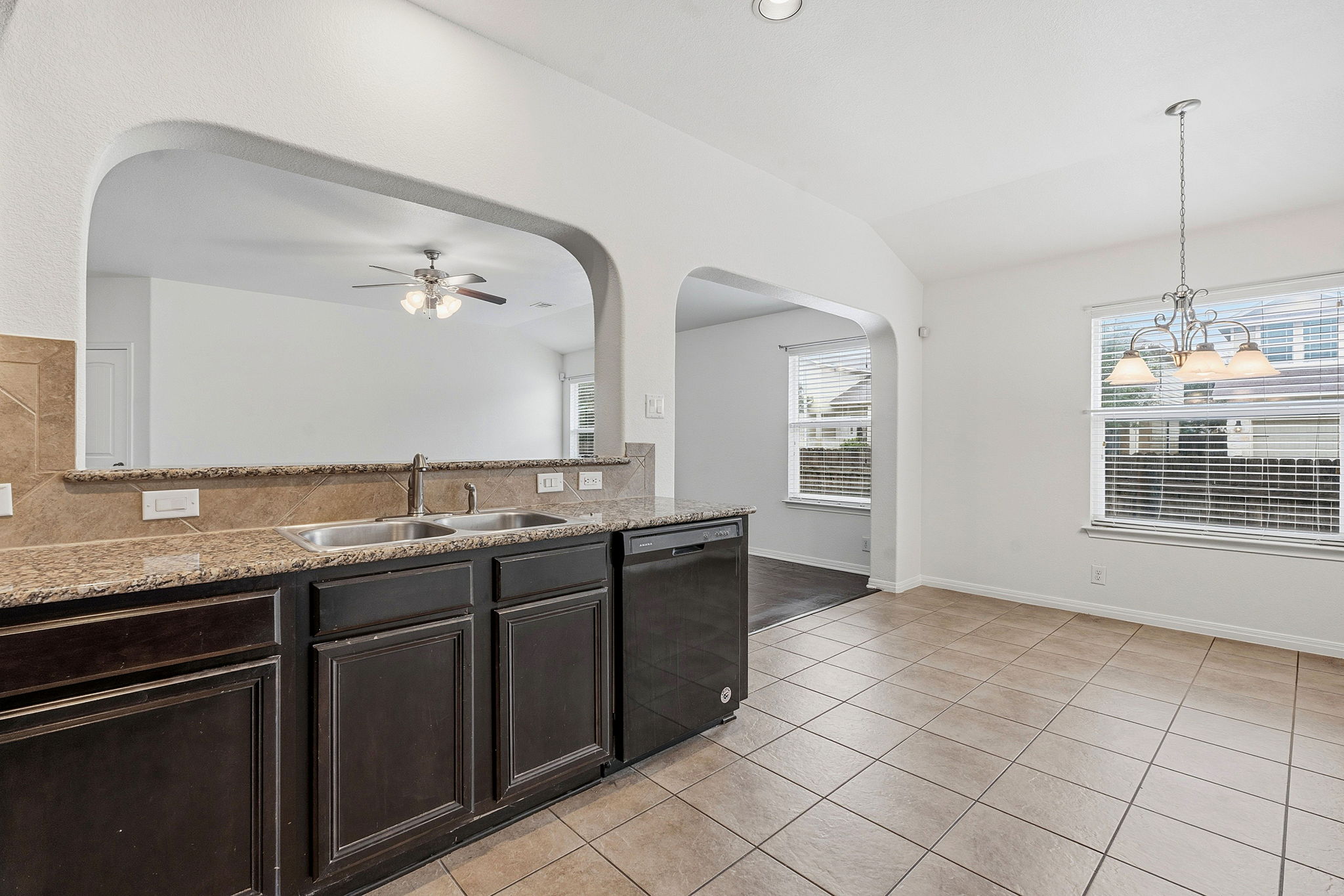 8541 Inca Dove Drive Austin, TX 78729 - Photo 12 of 28 The kitchen overlooks the main living area for seamless connectivity with bar seating along the arching opening.