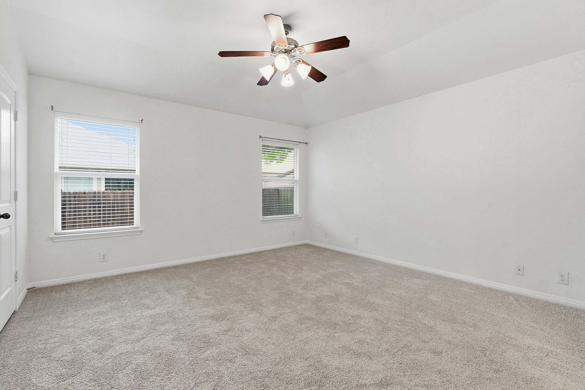 8541 Inca Dove Drive Austin, TX 78729 - Photo 14 of 28 Privately situated at the back of the home, the spacious primary suite overlooks the backyard and includes an ensuite bath plus walk-in closet.