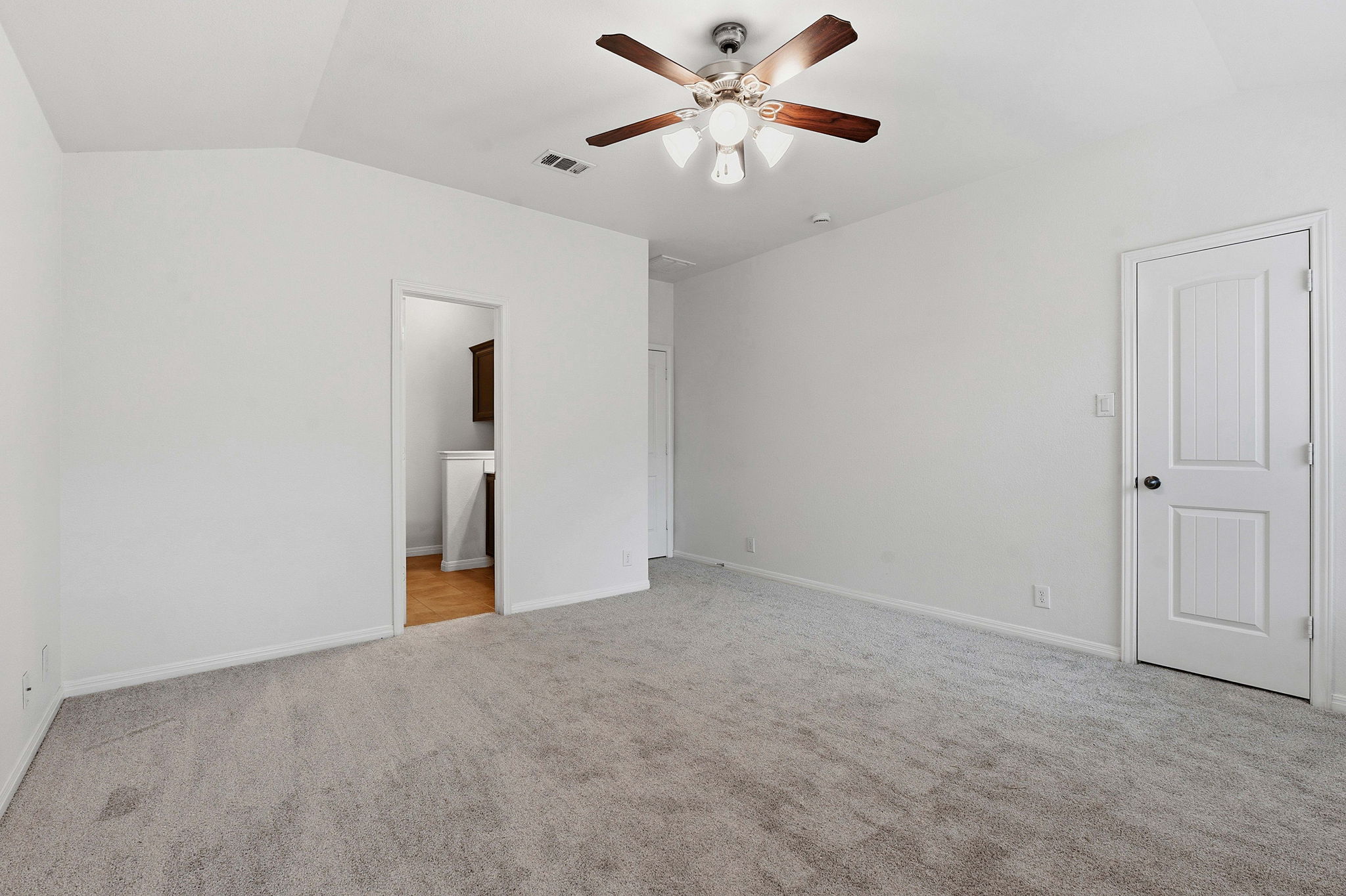 8541 Inca Dove Drive Austin, TX 78729 - Photo 15 of 28 The primary suite offers ample space for a king sized bed, side tables, and furniture.
