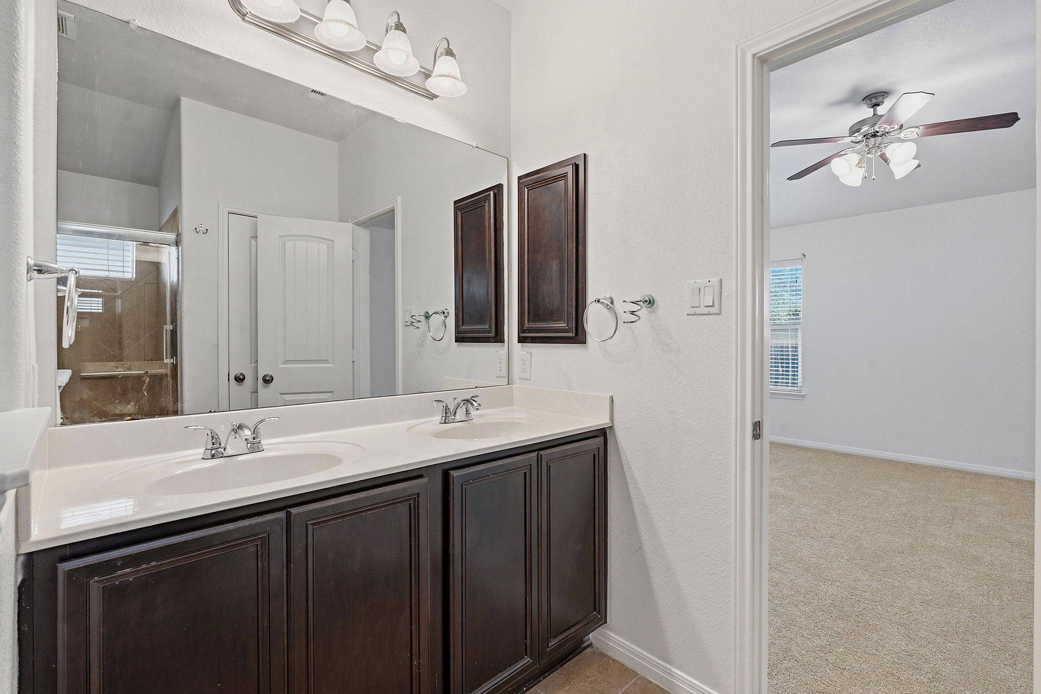 8541 Inca Dove Drive Austin, TX 78729 - Photo 18 of 28 The dual vanity boasts rich cabinetry below.