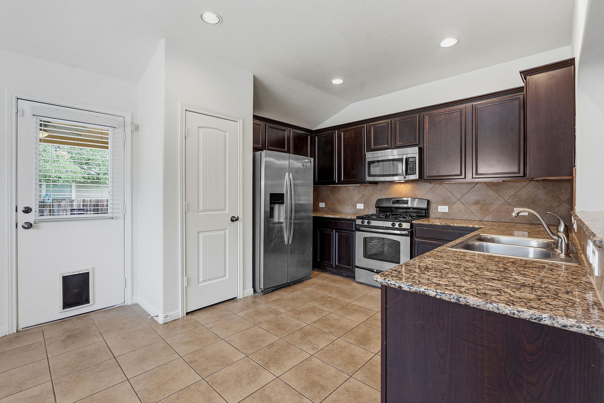 8541 Inca Dove Drive Austin, TX 78729 - Photo 9 of 28 The kitchen is designed for the home chef with desirable granite countertops, rich cabinetry, and pantry storage.