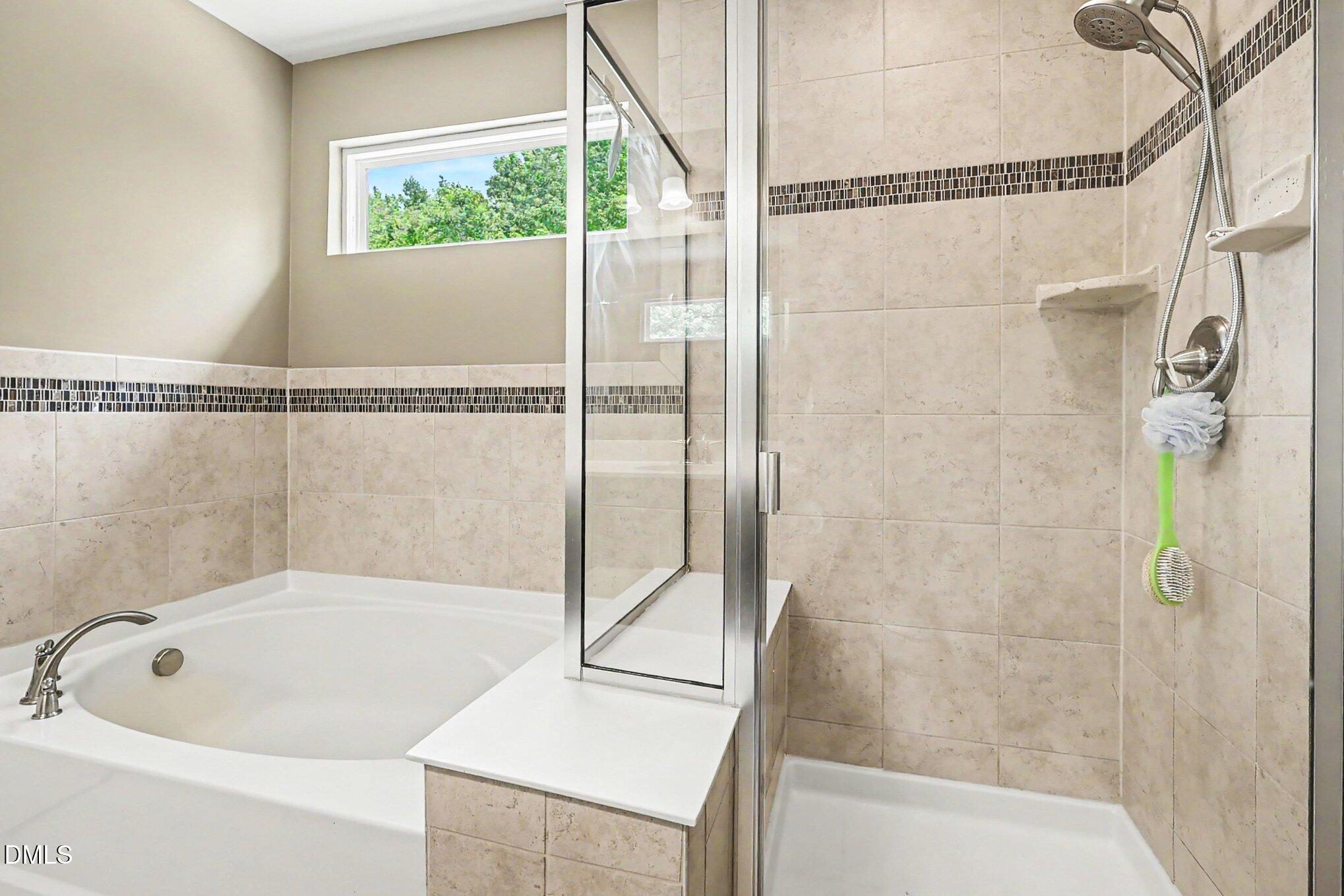 4366 Auburn Hills Drive Raleigh, NC 27616 - Photo 27 of 40 a bathroom with a bathtub and a shower