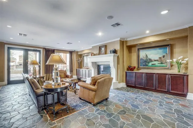 a living room with furniture a large window and a fireplace